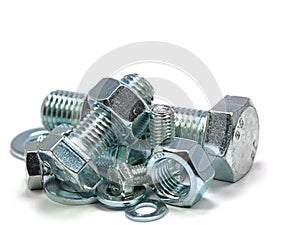 Metal screws and nuts in front of white background photo