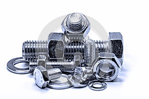 Metal screws and nuts in front of white background photo
