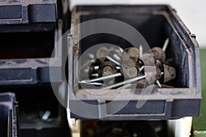 Metal screws in storage containers. Shelf locksmith workshop wit