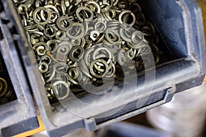 Metal screws in storage containers. Shelf locksmith workshop wit