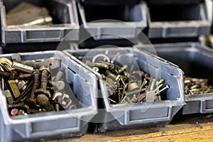 Metal screws in storage containers. Shelf locksmith workshop wit