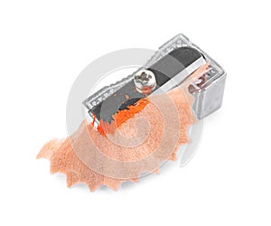 Metal sharpener with pencil shavings on white background