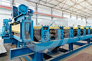 Metal sheet profiling factory. New modern roll forming machine photo