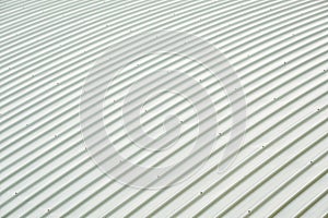 Metal sheet roof curve building. Orderly pattern of roofing metalsheet, large buildings