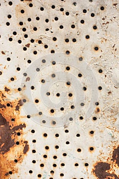Metal sheet texture with holes and rust