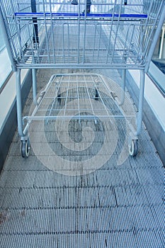 Metal Shopping cart on escalator