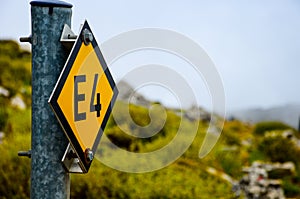 Metal sign of E4 showing a path in Lasithi, Crete, Greece