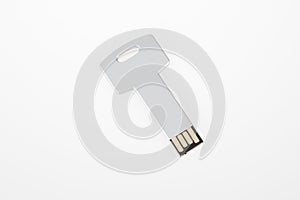 Metal silver grey USB key in the shape of a metal USB flash drive on white background