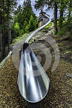 Metal slide in the alpine forest