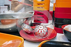 Metal Soup Ladles on a Sukiyaki Hot Pot table in a Restaurant