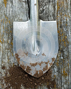 Metal spade and black soil