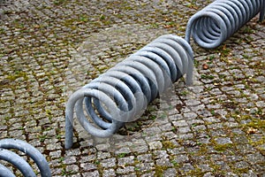 Metal spirals of empty bike stand on a bicycle parking lot