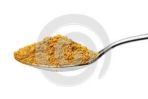 Metal spoon with ground Curry powder close up on white background