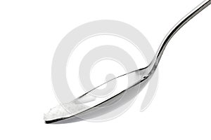 Metal spoon with a pinch of salt on white background