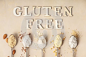 Metal spoons of various gluten free flour almond flour, oatmeal flour, buckwheat flour, rice flour, corn flour and