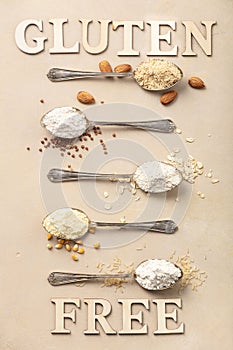 Metal spoons of various gluten free flour almond flour, oatmeal flour, buckwheat flour, rice flour, corn flour and