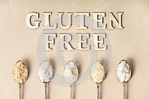 Metal spoons of various gluten free flour almond flour, oatmeal flour, buckwheat flour, rice flour, corn flour and