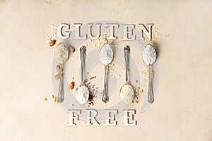 Metal spoons of various gluten free flour almond flour, oatmeal flour, buckwheat flour, rice flour, corn flour and gluten free