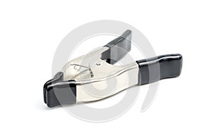 Metal spring clamp with black plastic on handles and tip on white background