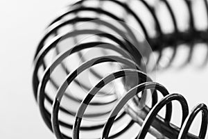 Metal spring coiled, black and white macro shot photo
