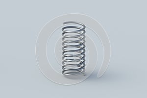 Metal spring on gray background. Flexibility wire