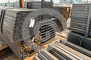 Metal square pipes in stock. Stacks of new square steel pipes at the factory