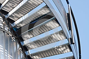 Metal staircase against a bright blue sky