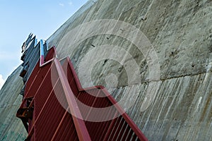 Metal stairs on the gray concrete wall