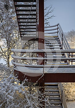 Metal stairs of industrial building in snowy winter