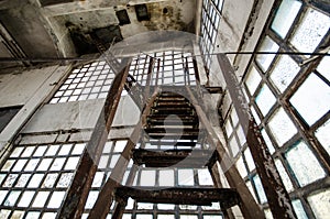Metal stairs in an old building with dirty windows
