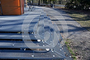 Metal stairs are wide and transparent. made of stainless steel grid. suitable for the park. the staircase connects to the nature p