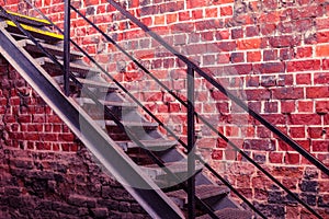 Metal stairway against old brick wall - vivid photo