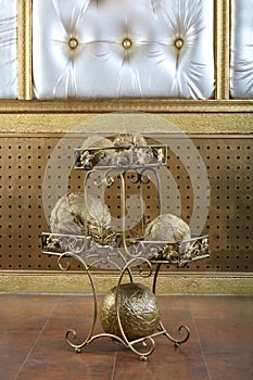 Metal stand with golden balls decorative element