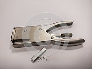 Metal staple with staple needles on a white background