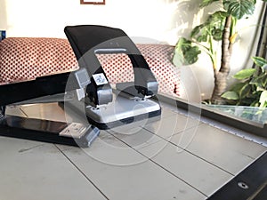 Metal stapler and paper hole puncher on paper cutter isolated,office and business work equipments