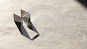 Arranged vertically on a textured, light-colored surface, casting