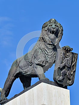 Metal statue of a lion with a symbol and emblem of Slovak statehood in Bratislava, Slovakia
