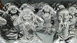 Metal statues of a boy who pretends not to hear, see and speak