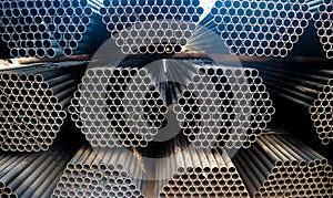 Metal steel and aluminium pipe heap in the cargo warehouse for transportation and logistics to the manufacturing factory