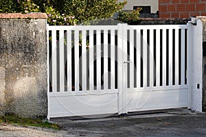 Metal steel gate white home fence on suburb street house