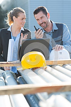 metal and steel pipes factory worker holding walkietalkie