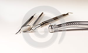 Metal, sterile dental instruments for oral sanitation, located in a sterile tray, prepared for the dentist.