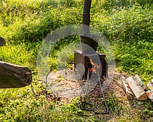 Metal stove with bucket of tar