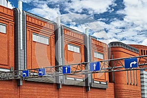 The metal structure with road signs and brick wall in an old brewery