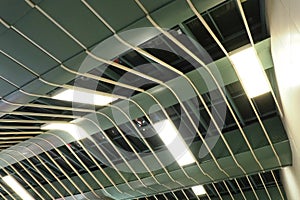 Metal structures under the ceiling. Decorative details of the airport ceiling . Concrete beams, glass lusters and metal