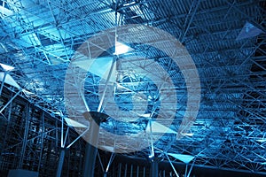 Metal structures under the ceiling. Decorative details of the airport ceiling . Concrete beams, glass windows and metal