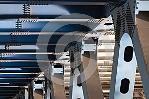 Metal supports of the bridge carrying heavy road - closeup view of bridge substructure