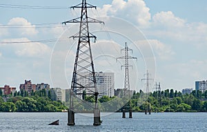 The metal supports of high-voltage power lines are installed in Voronezh River. Electric cables are connected two sides