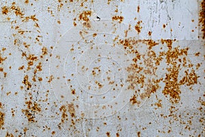 Metal surface with white paint that has passed temporary damage, a lot of formed, red rust.