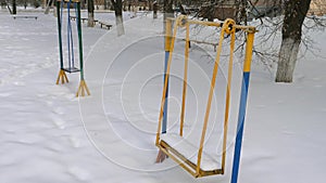 Metal swing in the snow.